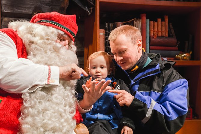 Arctic Delight - Visit to Santa's Village and snowmobiling to reindeer farm - Changing into thermal gear for the safari