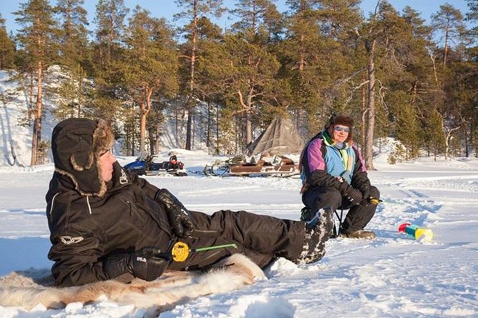 From Kakslauttanen: Ice Fishing Safari to Lake Inari, inc. lunch - Making your first hole in the ice