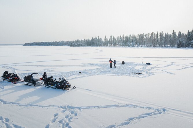 Ice Fishing and Snowmobile Safari Combo in Lapland - Sharing a snowmobile across Arctic forest