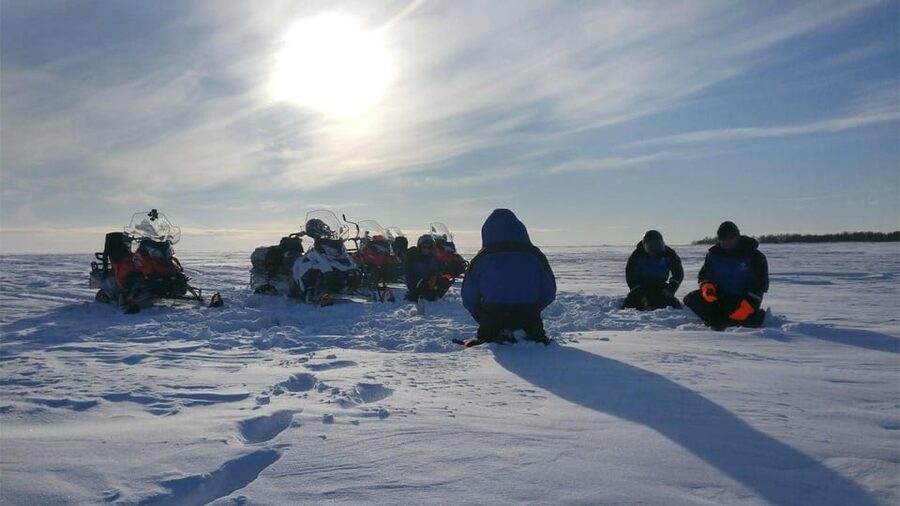 Kemi-Tornio: Ice Fishing Safari with Snowmobiles - Drilling a fishing hole in sea ice