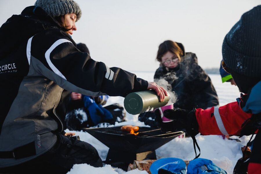 Rovaniemi: Ice Fishing & Snowmobile Safari Combo Day - Bonfire sausages and hot berry drinks