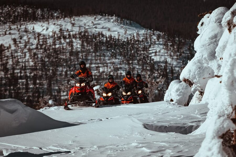 Saariselkä: Snowmobile Ride with Hot Drinks - Following the guide through snowy forests and hills