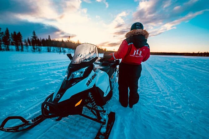 Snowmobile and Ice Fishing Experience - Drilling through the frozen lake