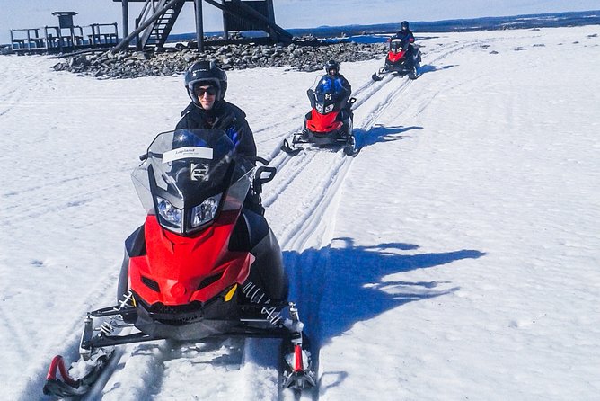 Snowmobile Safari in the Nature - Riding through forests, lakes, and open winter routes